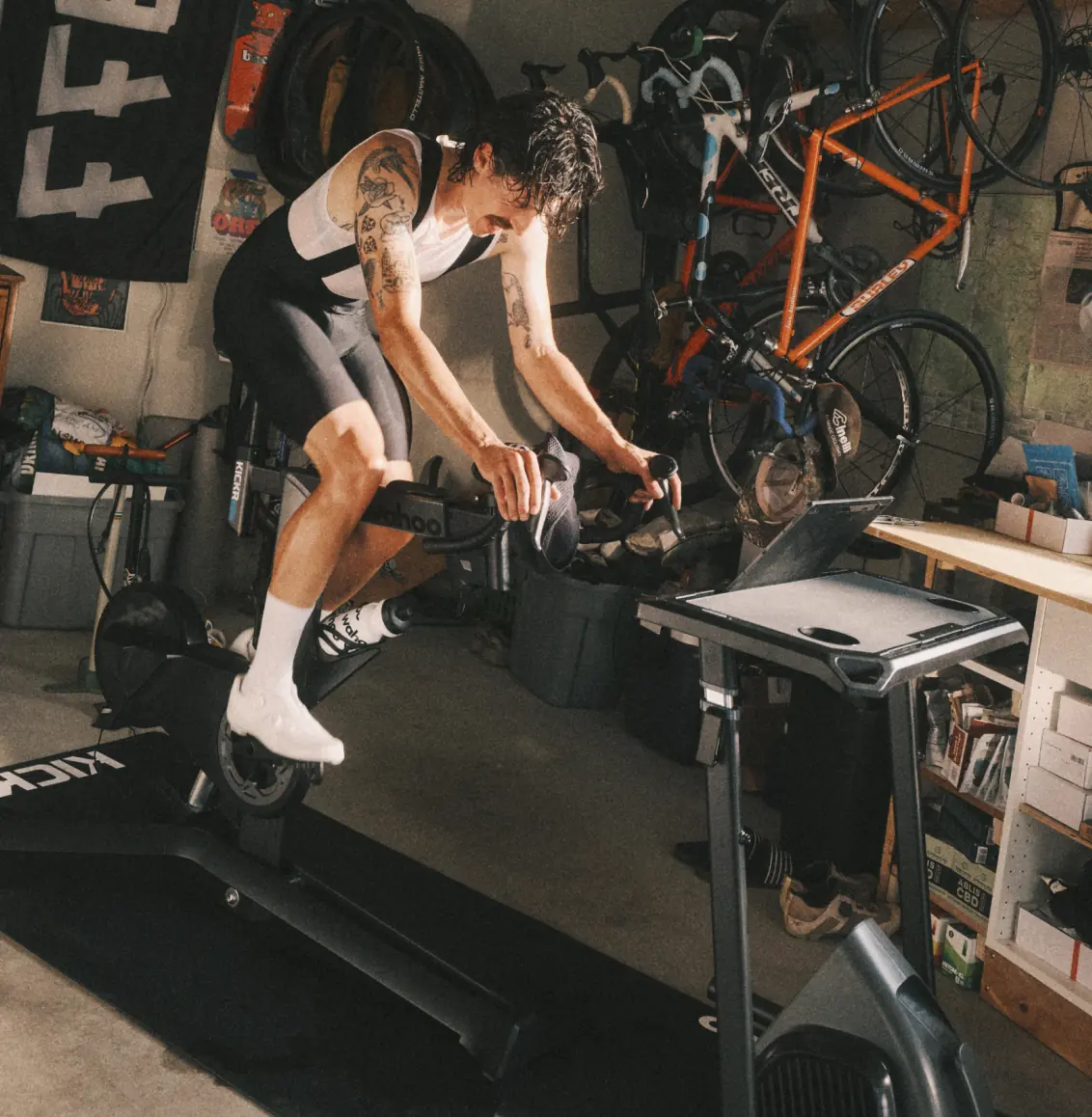Cyclist riding a Wahoo KICKR BIKE PRO smart bike in a home garage training setup