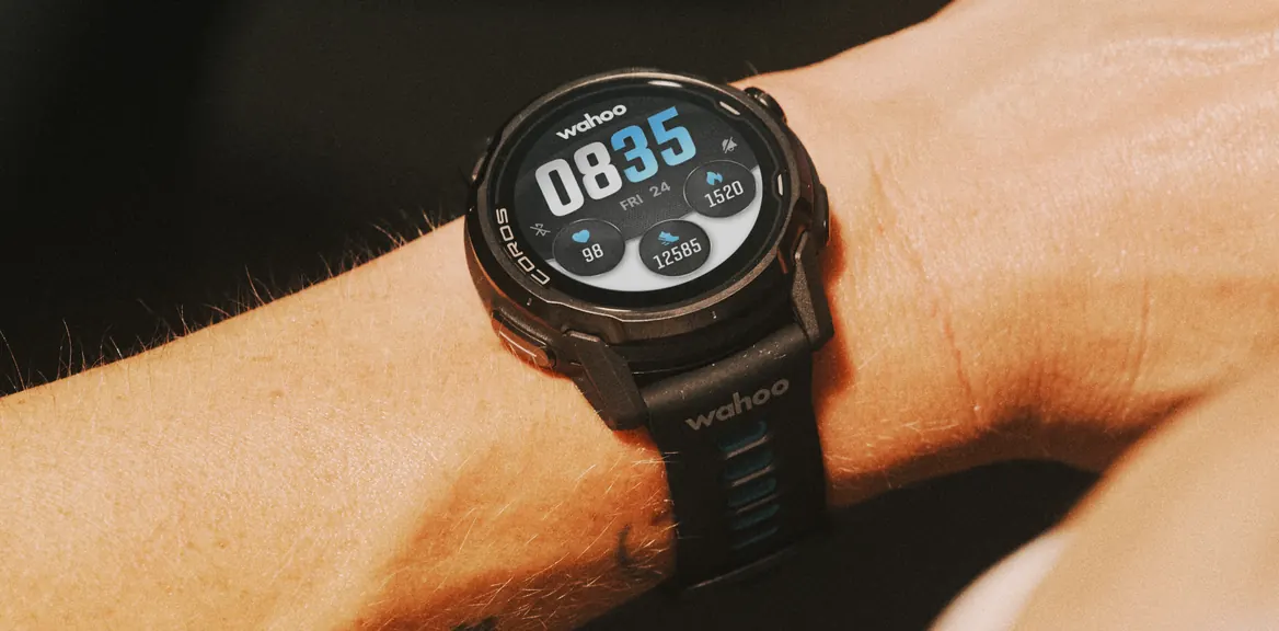 A COROS GPS watch on a wrist showing the time and daily activity stats