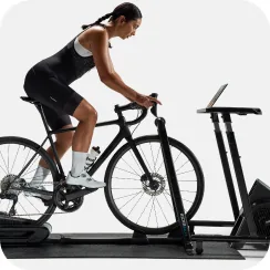 Cyclist using a Wahoo KICKR smart trainer indoors, connected to the Wahoo ecosystem